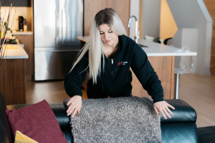 UrbanMop cleaner tidying a living room in Ottawa