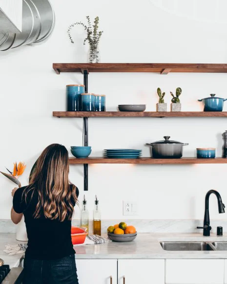 Woman cleaning a bright modern kitchen