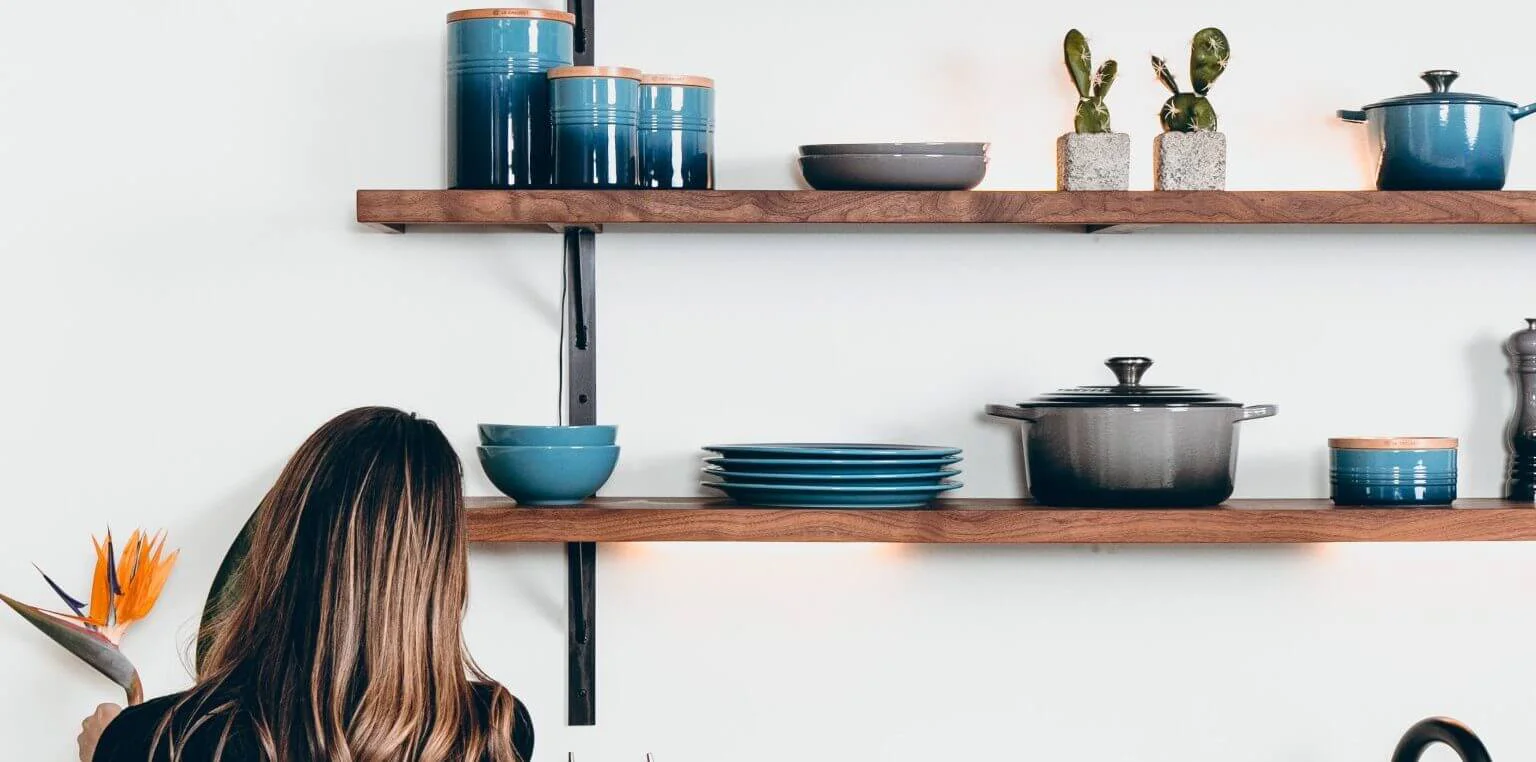 Woman cleaning and tidying a modern kitchen